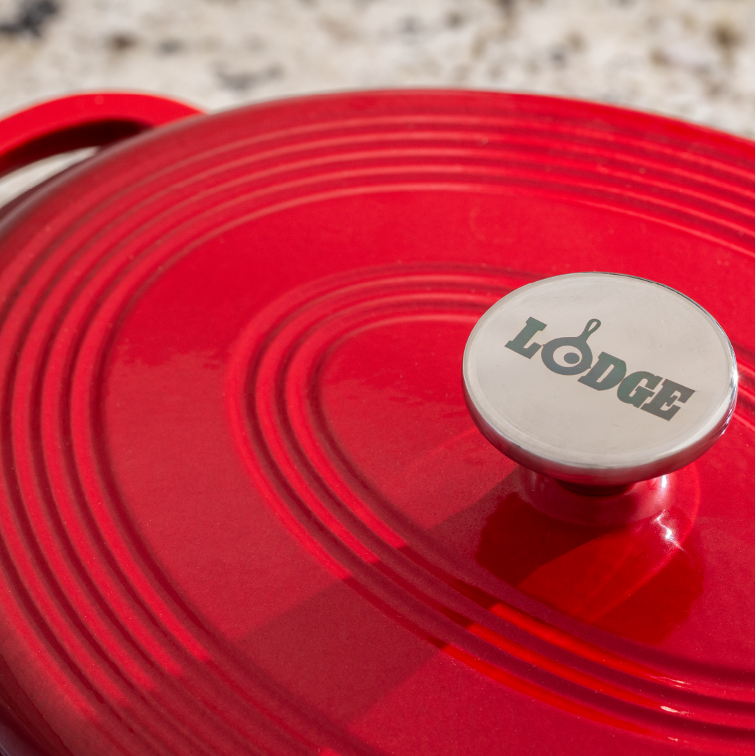 Close up of lid with silver knob containing Lodge branding.