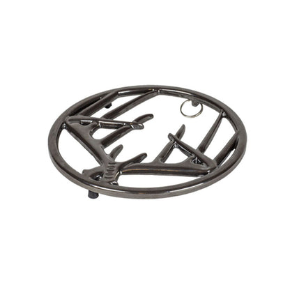 Black midnight chrome enamel trivet with decorative antler design on a white background