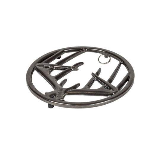Black midnight chrome enamel trivet with decorative antler design on a white background