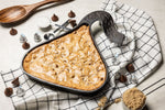 Freshly baked blondie in a skillet shaped like a wrapper Hershey's Kiss..