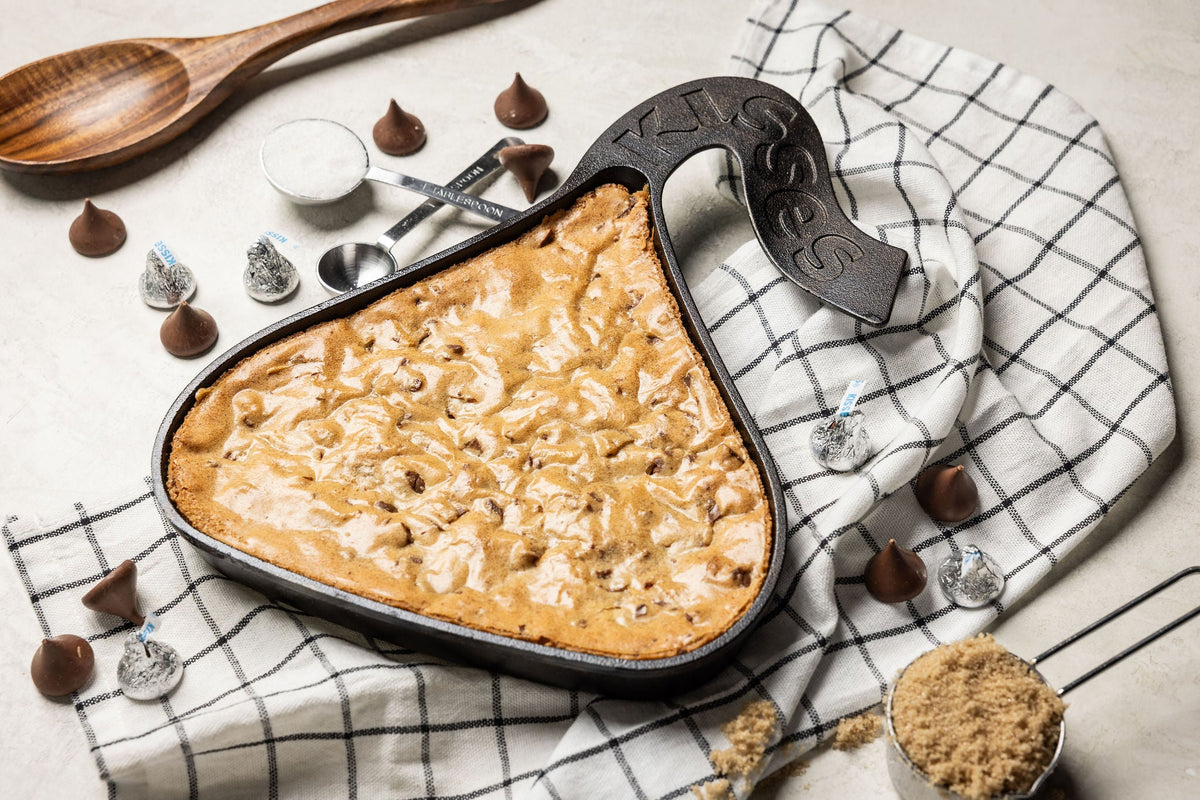Freshly baked blondie in a skillet shaped like a wrapper Hershey's Kiss..