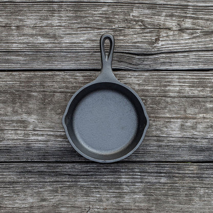 Skillet on wooden background.