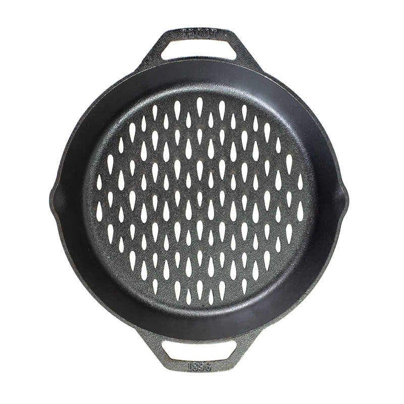 Top view of pan showing teardrop shaped holes so flame can reach food without losing anything between the grates.