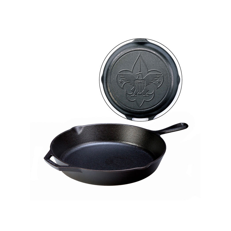A black cast iron skillet with a long handle, loop handle, and 2 pour spouts, featuring a Boy Scout design on the back of skillet.