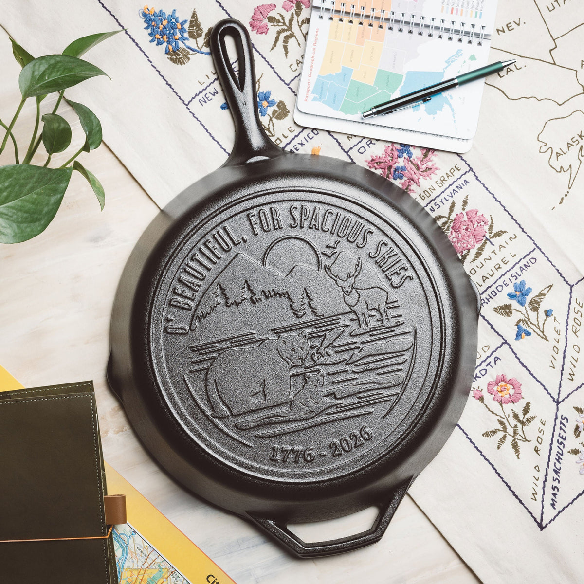 Black cast iron skillet with engraved design on a map background.