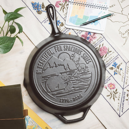 Black cast iron skillet with engraved design on a map background.