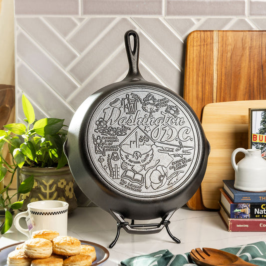 Decorative cast iron skillet with Washington DC design on a kitchen counter.