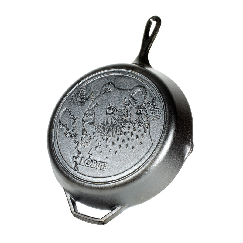 Cast iron skillet with bear design and 'Lodge' branding.