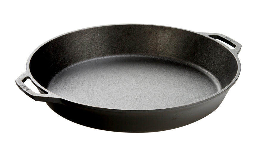 Black cast iron skillet with two loop handles.