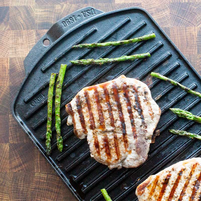 Grilled chicken and asparagus prepared on grill pan.