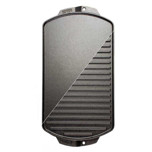A black cast iron reversible grill/griddle with grooves on one side and a smooth surface on the other, branded with 'Lodge'.