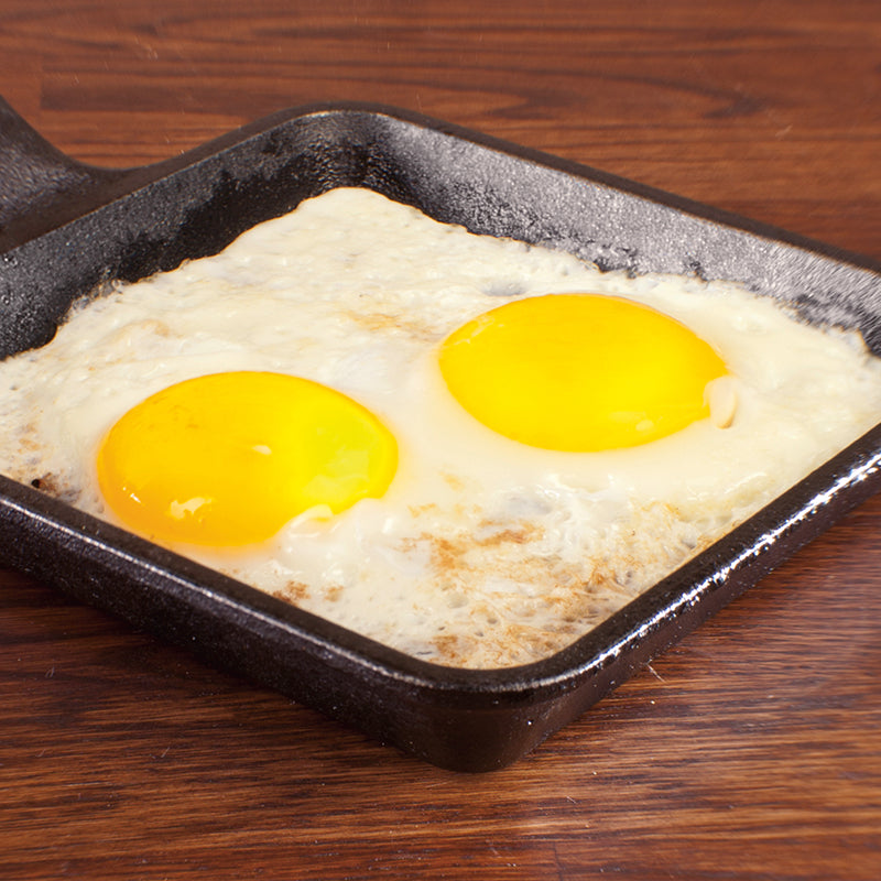 Sunny side eggs fried in skillet.