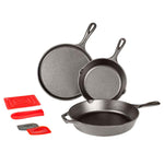 Set of three cast iron skillets with red silicone trivets, handle holder, and 2 scrapers.