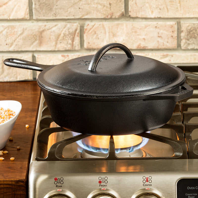 Deep skillet being used on stove with lid.