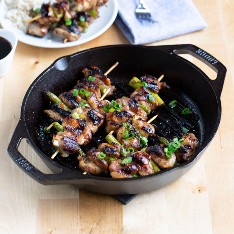 Freshly made chicken skewers, prepared and served in grill pan.