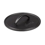 A black round seasoned cast iron grill press with a handle in the center.