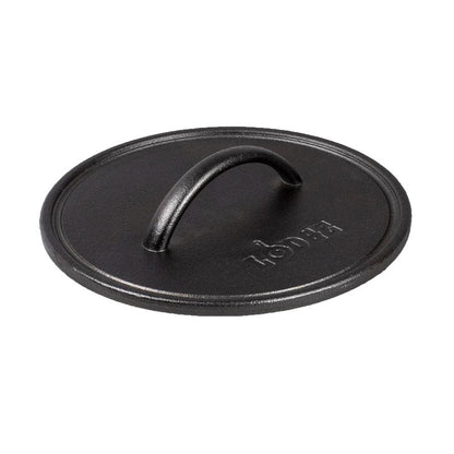 A black round seasoned cast iron grill press with a handle in the center.