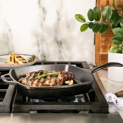 Someone cooking steak over stove.