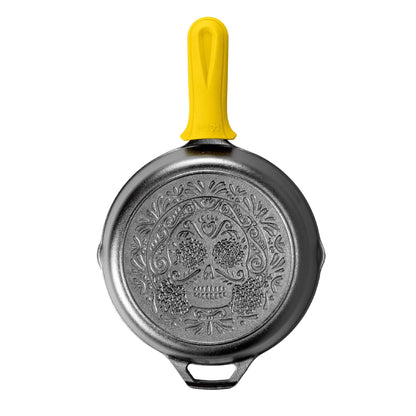 Black skillet with an engraved Sugar Skull design on the back with Deluxe Handle Holder.