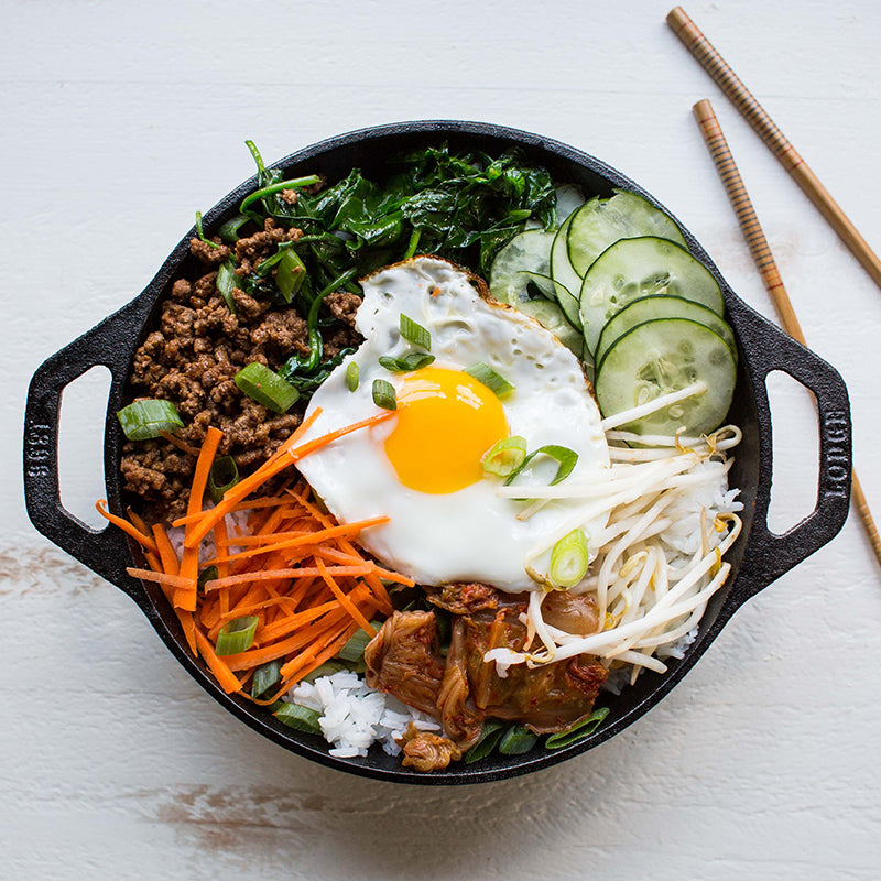 Stir fry bowl freshly prepared and served in wok with chopsitcks.