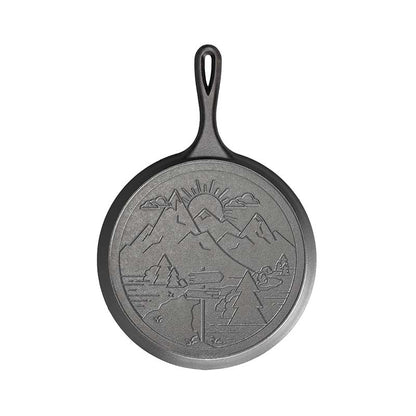 Round griddle with an engraved mountain design on the back.