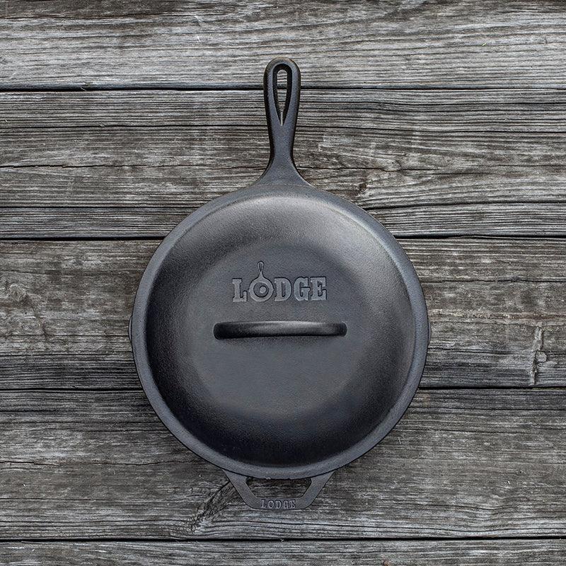 Top view of lid on skillet, displaying branding and handle.