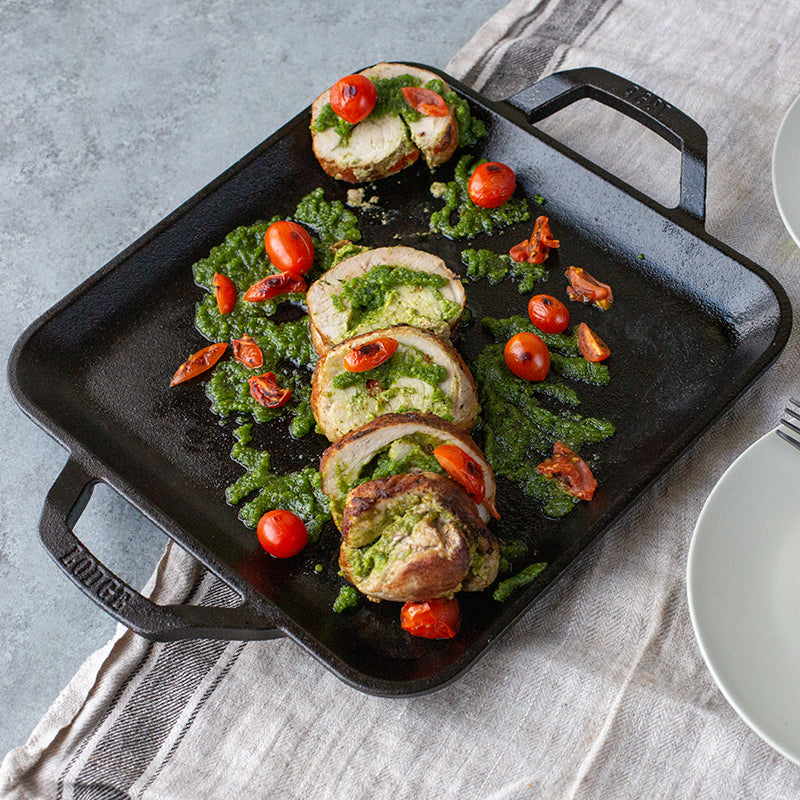 Freshly prepared chicken with pesto and tomato's, made and served on griddle.