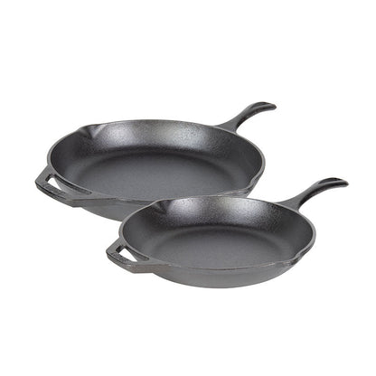 Two cast iron skillets on a white background