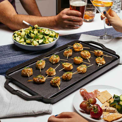 Bacon wrapped scallops prepared and served on griddle.