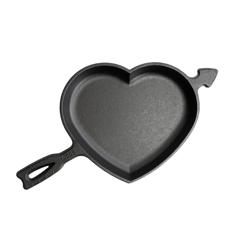 A black heart-shaped cast iron skillet with a handle and arrow design.