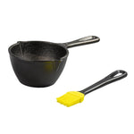 Black cast iron melting pot with a yellow brush on a white background