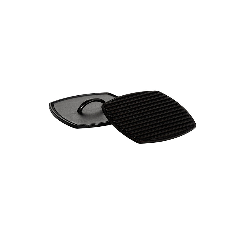 Square cast iron press with handle on top, and lines on the bottom.