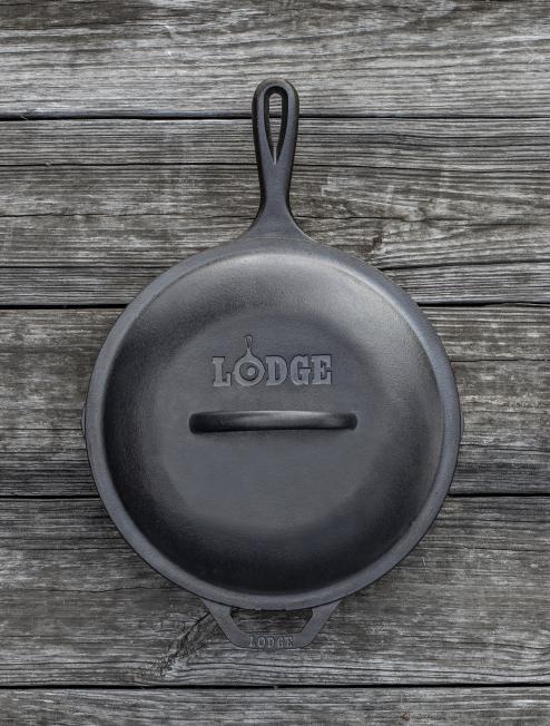 Top view of lid on skillet, displaying branding and handle.