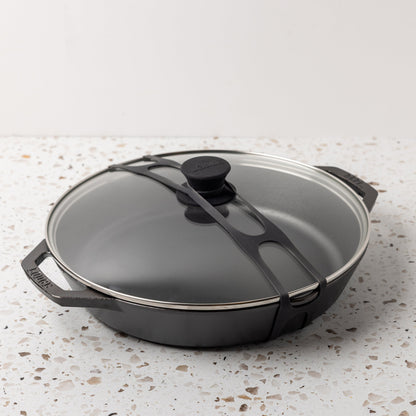 Black lid latch being used on our everyday pan with glass lid.