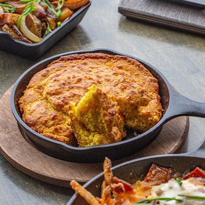 Partially eaten cornbread, served in skillet with underliner.
