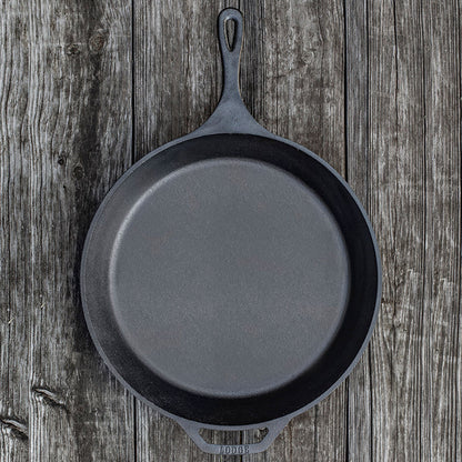 Skillet on wooden background.