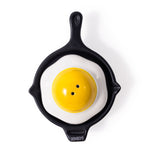 A stackable salt and pepper shaker, one piece shaped as a skillet, the other has a fried egg.