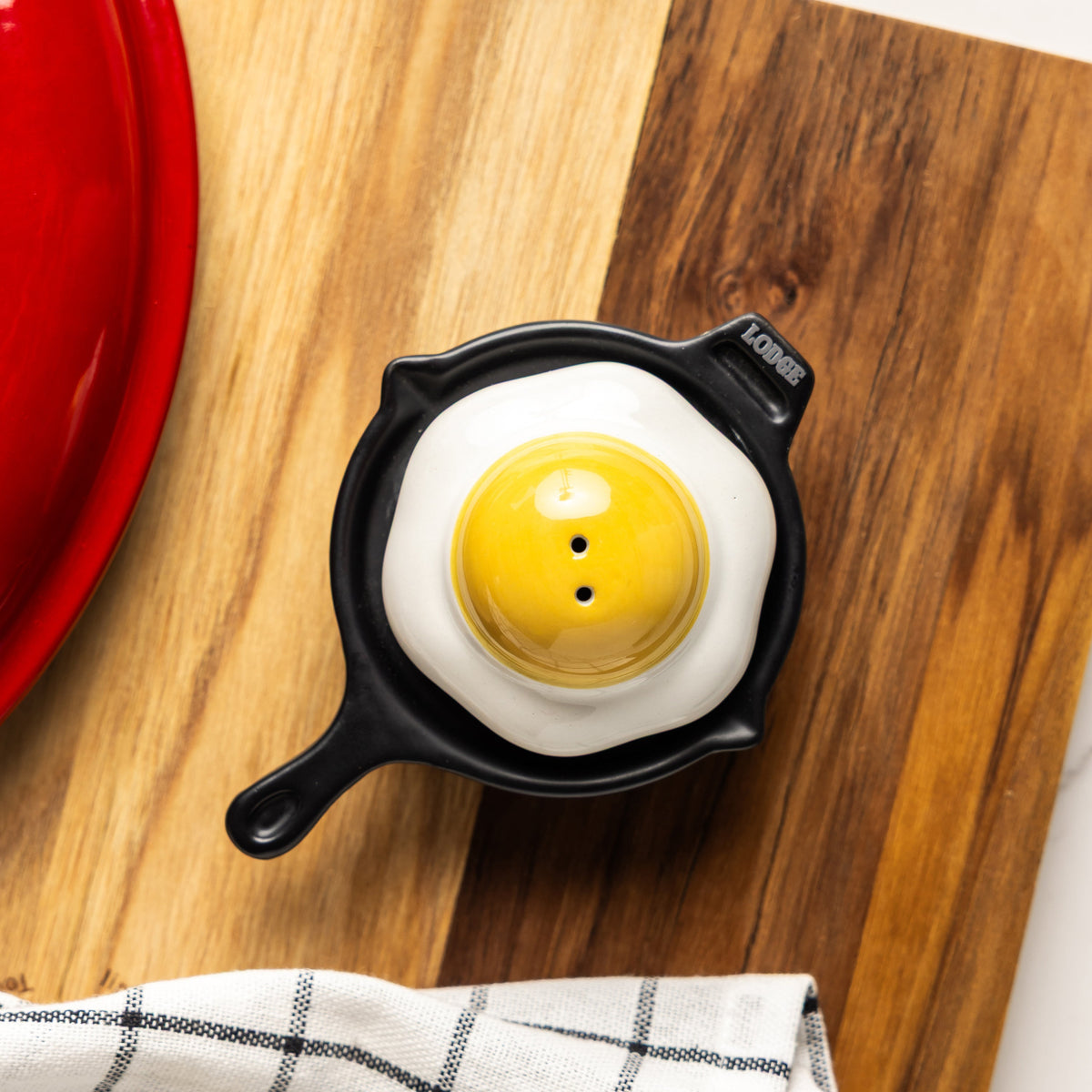 Fried egg and a skillet shaped salt and pepper shaker on a table.