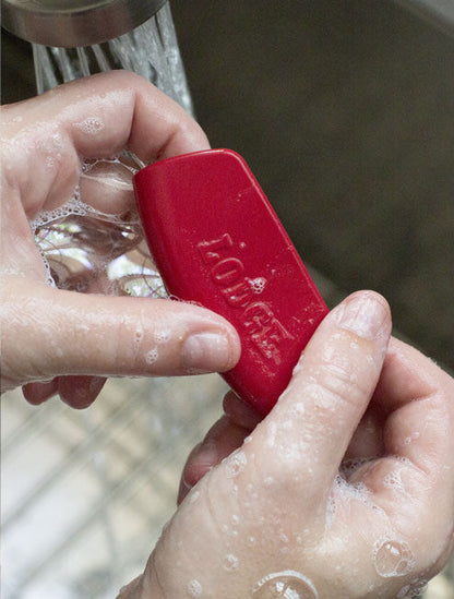 Grips being washed with soap and water.