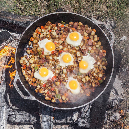 Hashbrown's and eggs cooking over campfire.