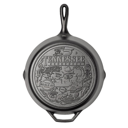 Black cast iron skillet with 'Tennessee' design on a white background