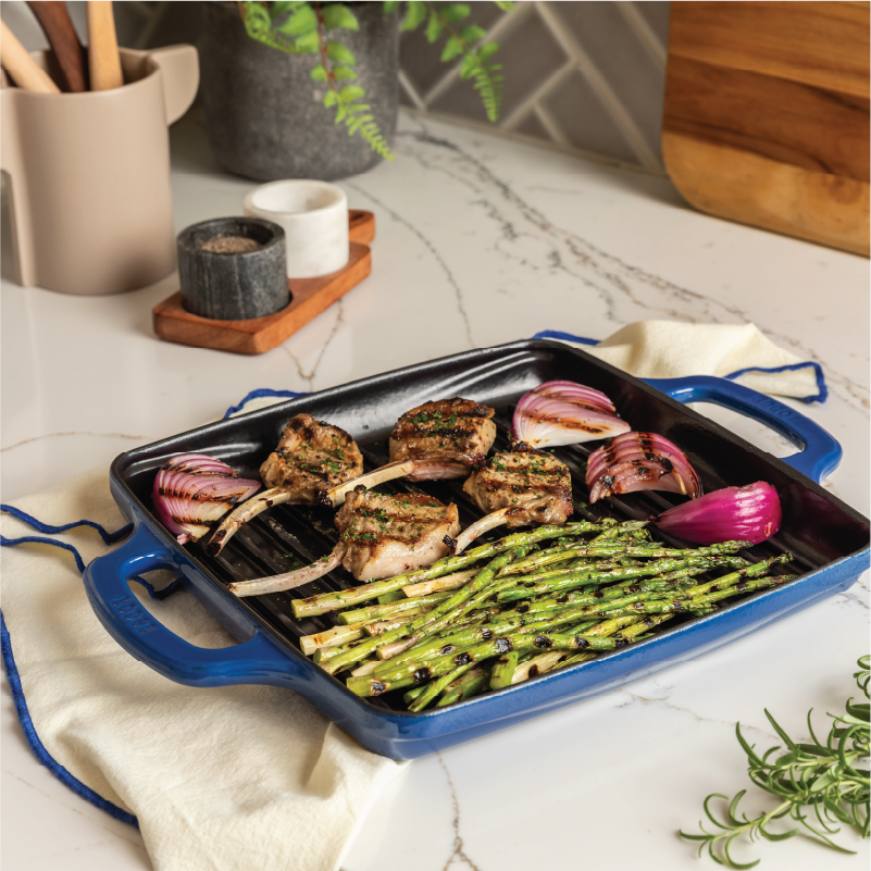 Freshly made meal served on grill pan in kitchen.