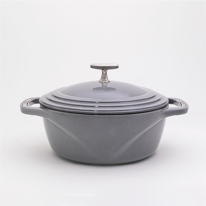 Grey enameled cast iron Dutch oven with a lid on a white background