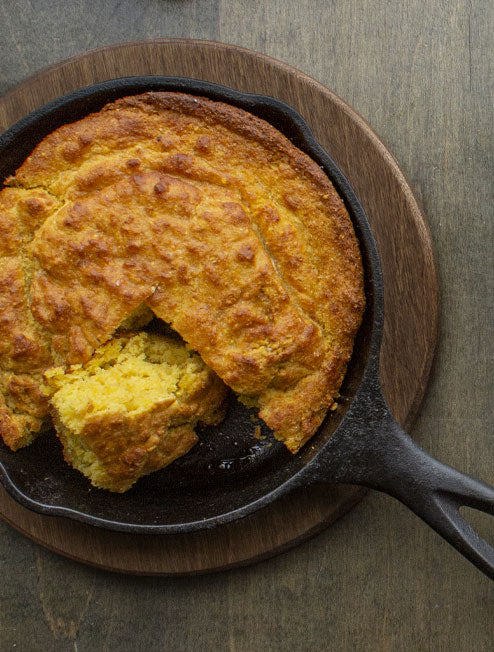 Fresh cornbread served in skillet on underliner.