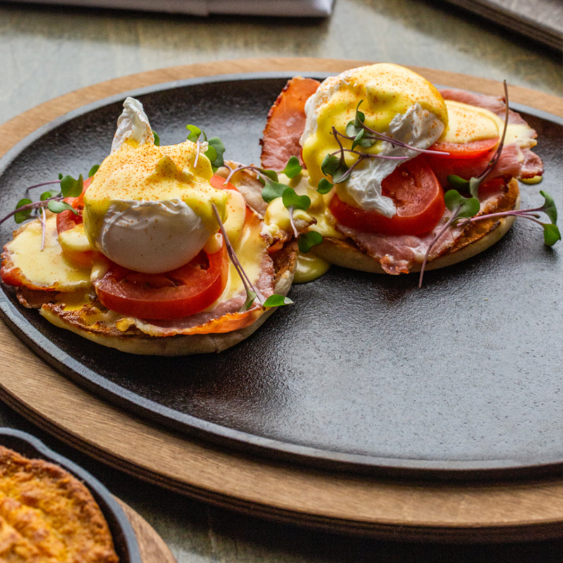 Fresh eggs benedict, served on griddle with underliner.