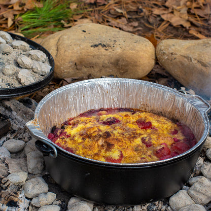 Fresh dish being cooking in camp dutch oven with liner.