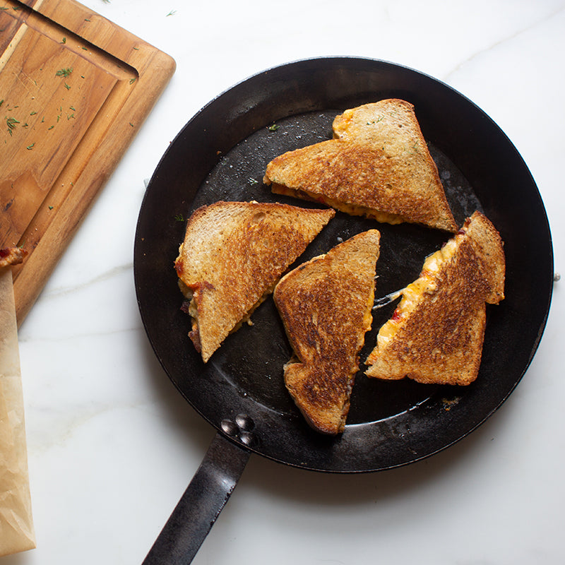 Fresh grilled cheese prepared and served in skillet.