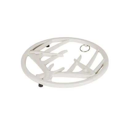 White enamel trivet with decorative antler design on a white background