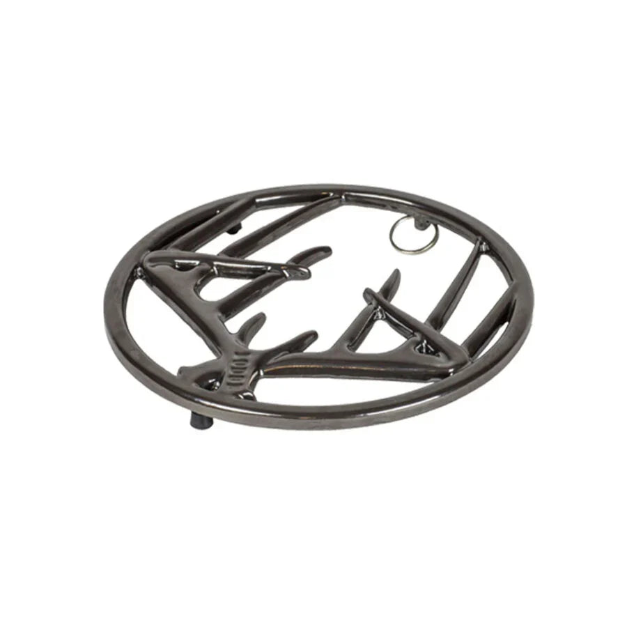 Black midnight chrome enamel trivet with decorative antler design on a white background