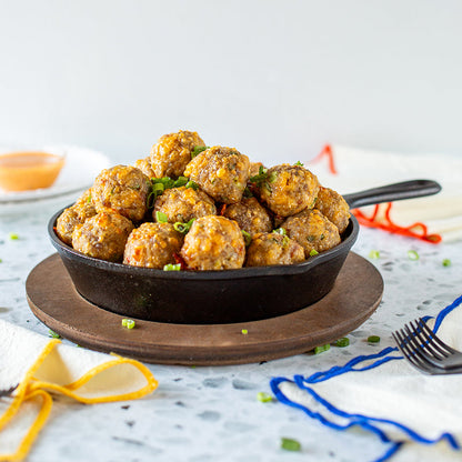 Fresh sausage balls served in skillet with underliner.
